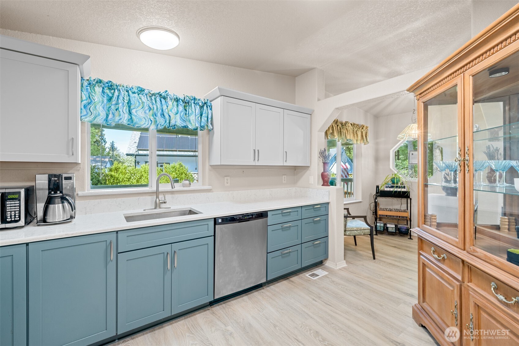 423 Fleming Drive Sequim, WA 98382 - Photo 12 of 33 a kitchen with a sink and wooden cabinets