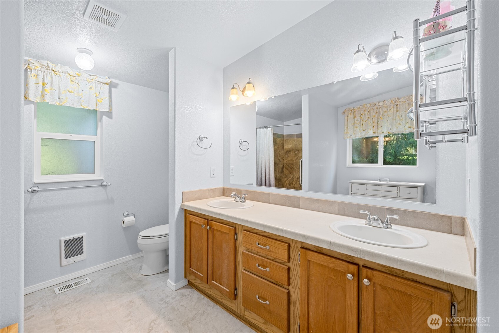 423 Fleming Drive Sequim, WA 98382 - Photo 17 of 33 a spacious bathroom with a granite countertop sink toilet and a mirror
