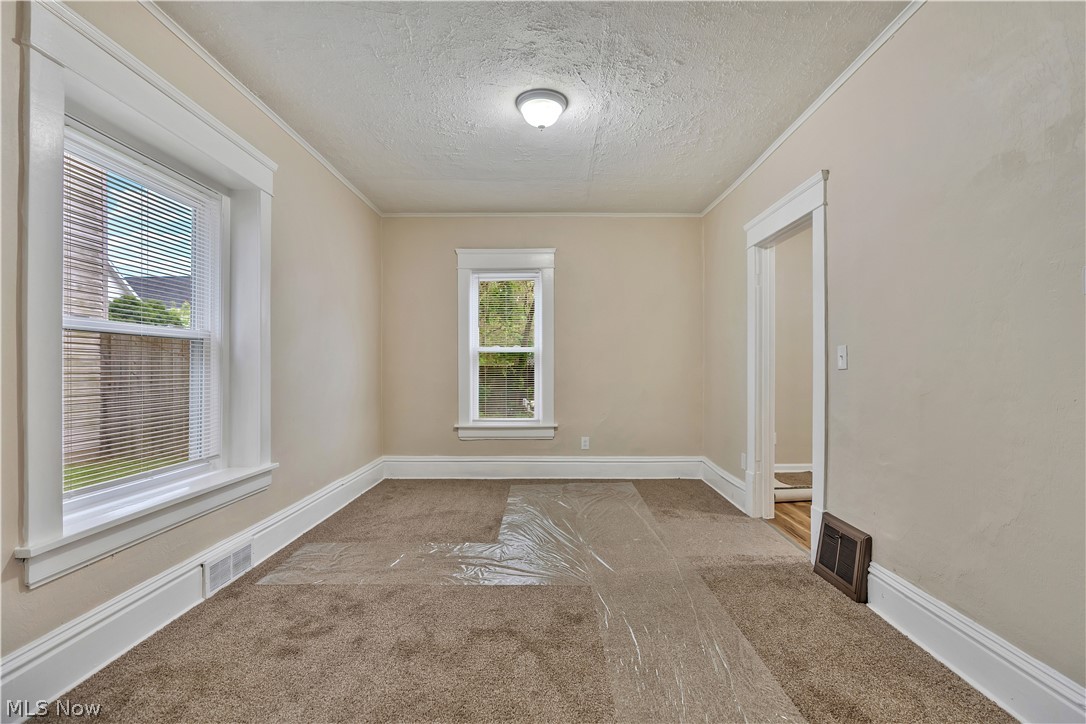 796 Dayton Street Akron, OH 44310 - Photo 9 of 25 Neutral-toned room featuring carpeted flooring and light-colored walls