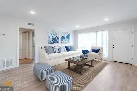 a living room with furniture and a wooden floor
