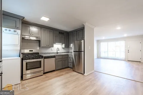 a kitchen with stainless steel appliances granite countertop a stove a refrigerator and a microwave