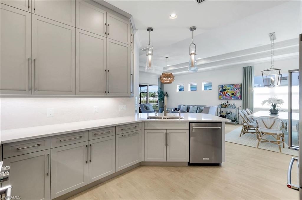 8825 Yucatan Court Naples, FL 34113 - Photo 11 of 45 a kitchen with cabinets a sink and appliances