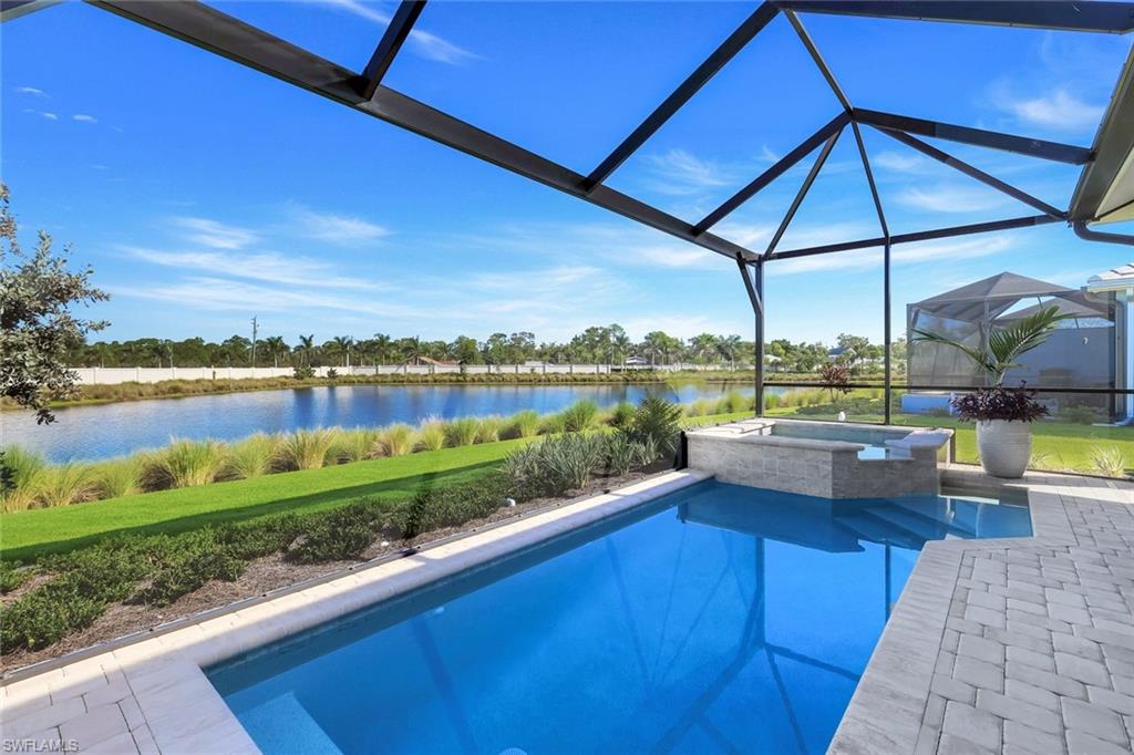 8825 Yucatan Court Naples, FL 34113 - Photo 2 of 45 a view of a swimming pool and outdoor seating