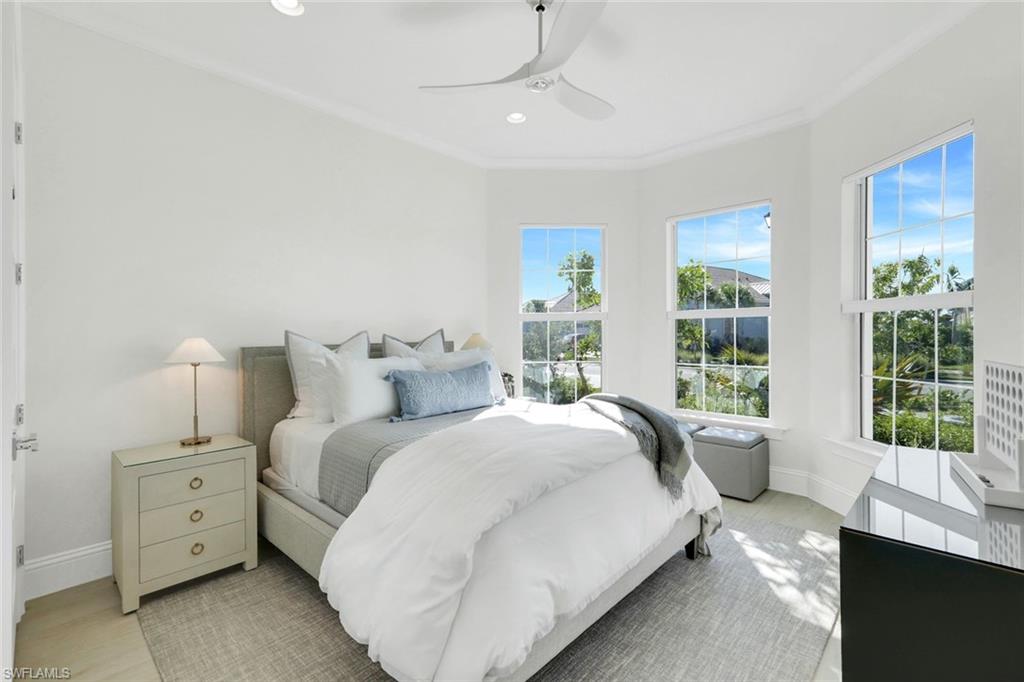 8825 Yucatan Court Naples, FL 34113 - Photo 23 of 45 a spacious bedroom with a bed and a window