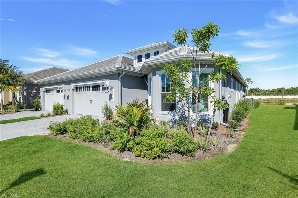 8825 Yucatan Court Naples, FL 34113 - Photo 3 of 45 a front view of a house with garden