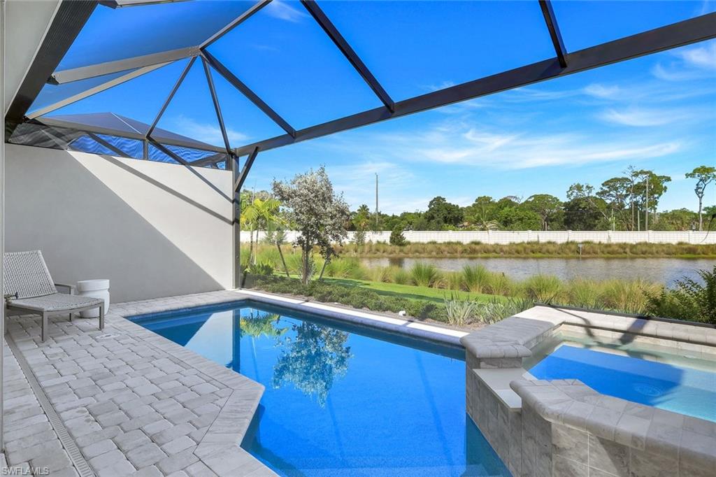 8825 Yucatan Court Naples, FL 34113 - Photo 31 of 45 a view of a swimming pool with a patio
