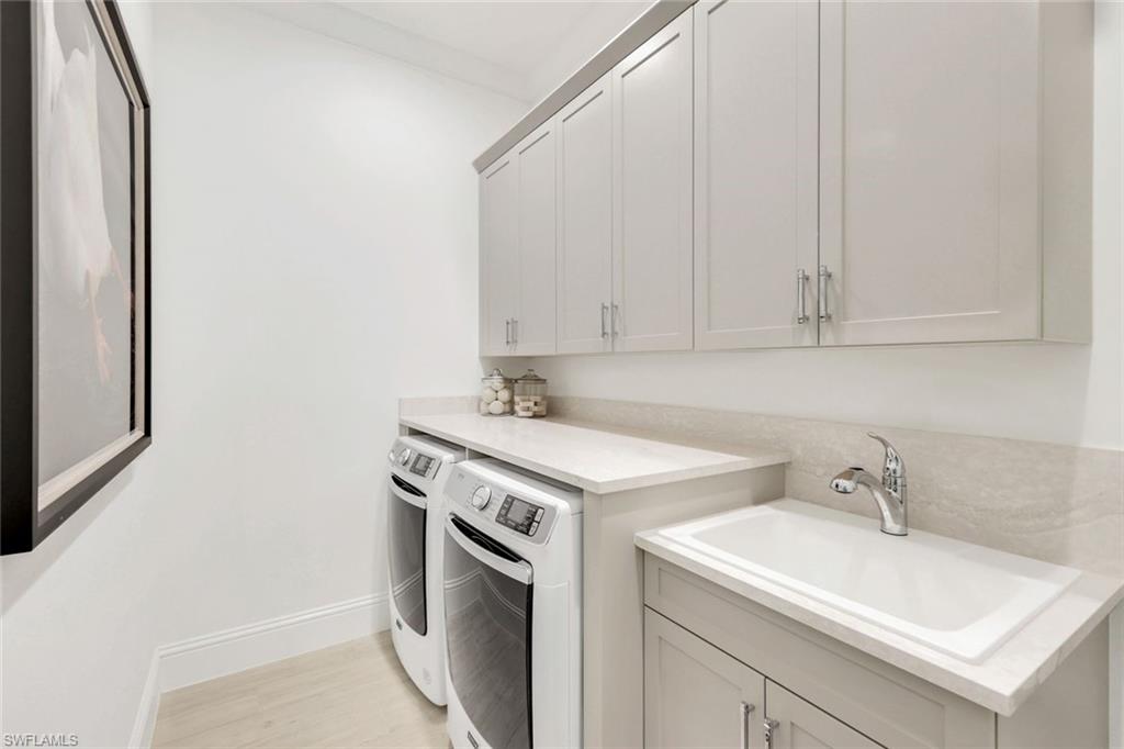 8825 Yucatan Court Naples, FL 34113 - Photo 32 of 45 a utility room with sink dryer and washer