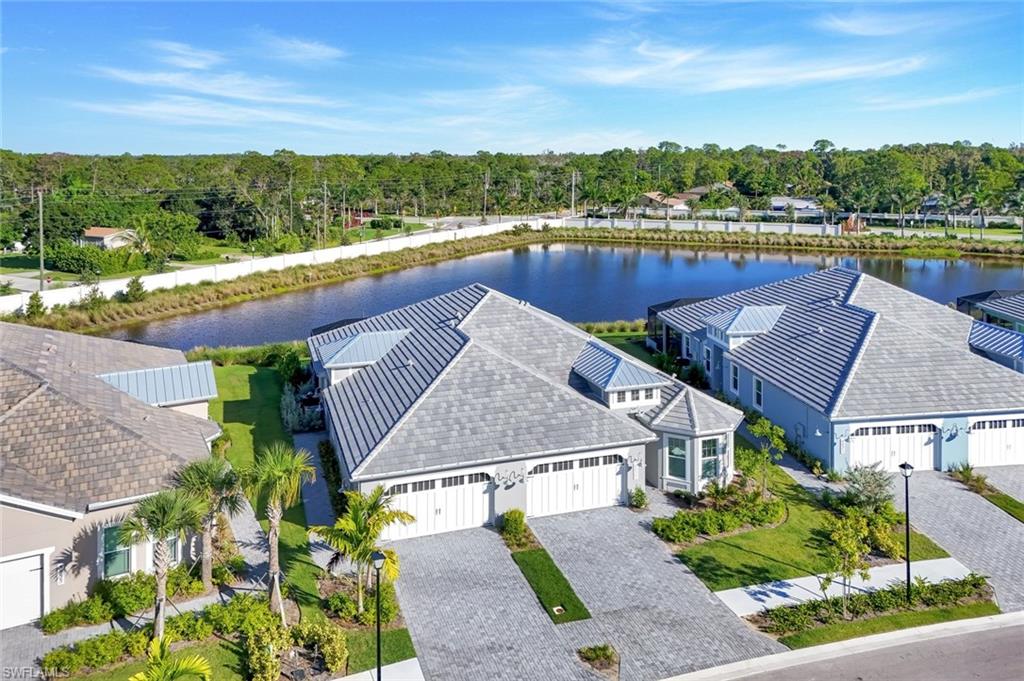 8825 Yucatan Court Naples, FL 34113 - Photo 33 of 45 a view of a lake with a mountain in the background
