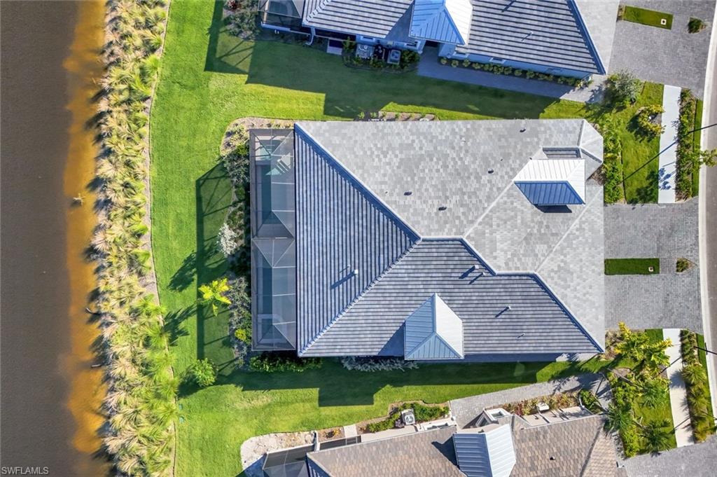 8825 Yucatan Court Naples, FL 34113 - Photo 35 of 45 an aerial view of a house with swimming pool and a yard