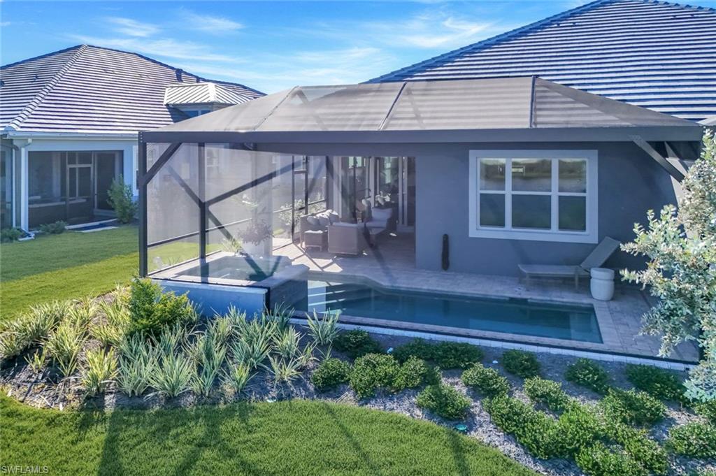 8825 Yucatan Court Naples, FL 34113 - Photo 36 of 45 a house view with a seating space and garden