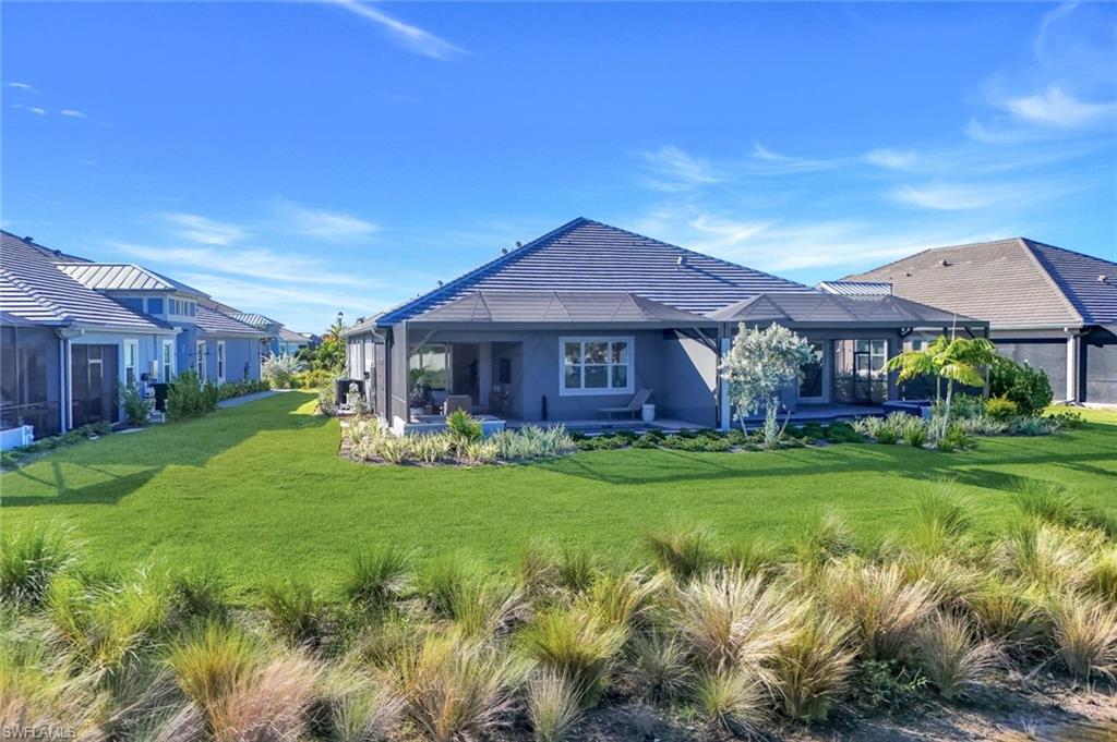 8825 Yucatan Court Naples, FL 34113 - Photo 37 of 45 a front view of a house with a yard