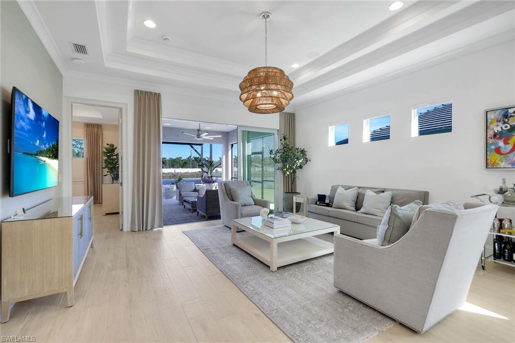 8825 Yucatan Court Naples, FL 34113 - Photo 4 of 45 a living room with furniture chandelier and a window
