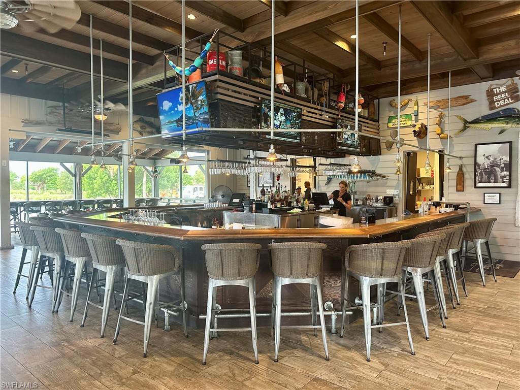 8825 Yucatan Court Naples, FL 34113 - Photo 45 of 45 a dining table with chairs and chandelier