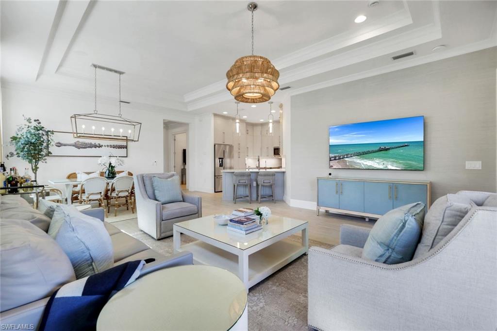 8825 Yucatan Court Naples, FL 34113 - Photo 7 of 45 a living room with furniture a chandelier and a table