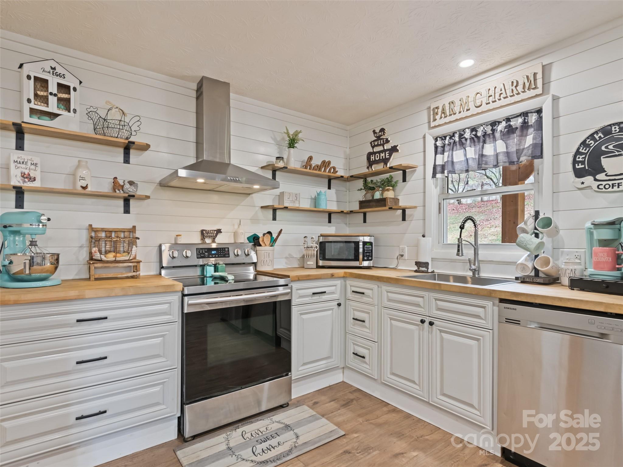 148 Mingus Cove Road Canton, NC 28716 - Photo 1 of 34 a kitchen with cabinets a sink and white stainless steel appliances