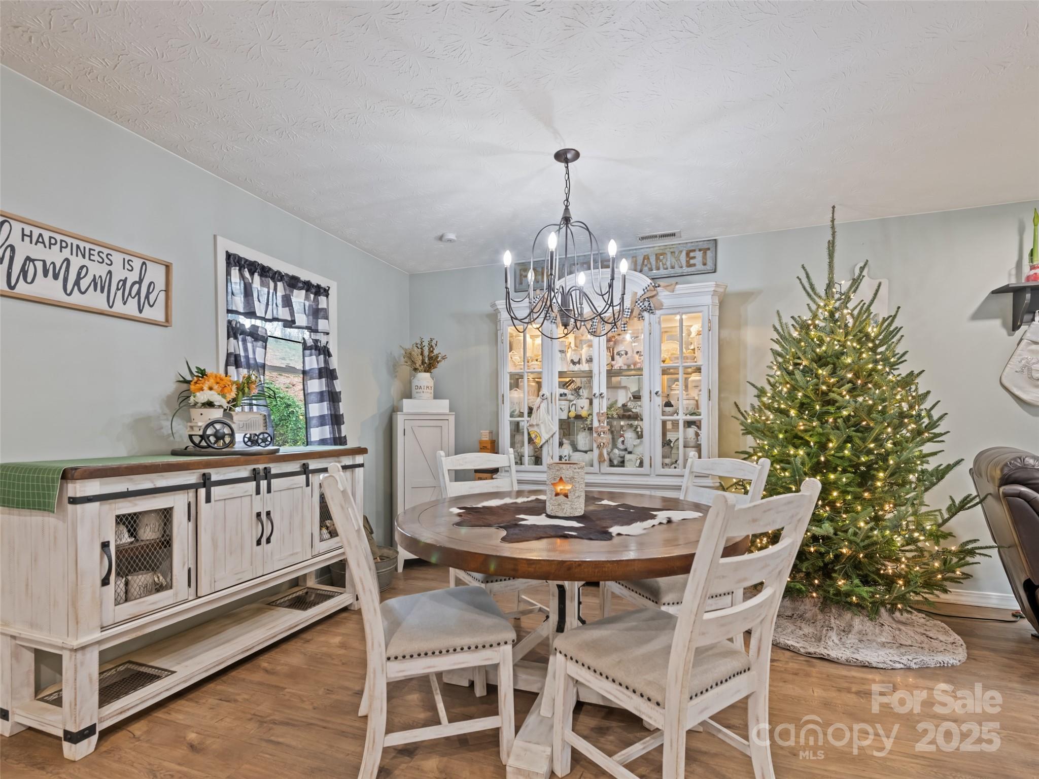 148 Mingus Cove Road Canton, NC 28716 - Photo 14 of 34 a view of a dining room with furniture and chandelier