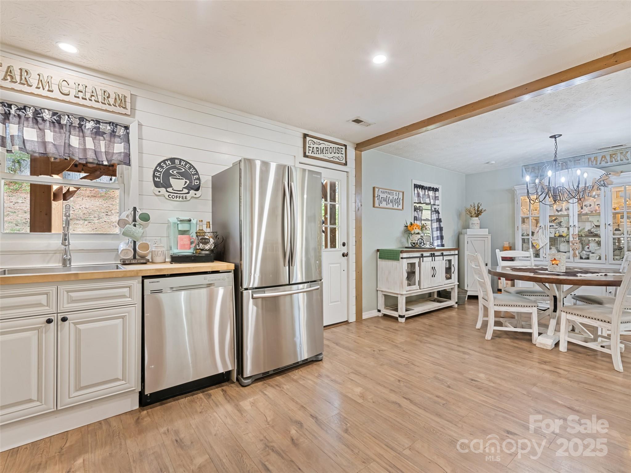148 Mingus Cove Road Canton, NC 28716 - Photo 8 of 34 a kitchen with granite countertop a refrigerator a sink a dining table and chairs