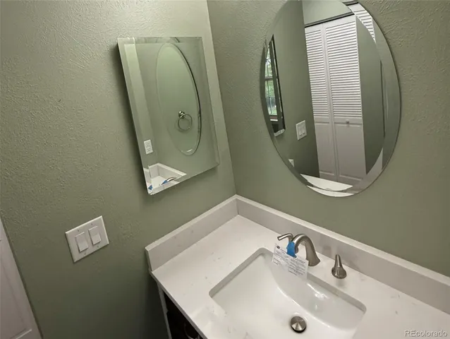 a bathroom with a sink and mirror