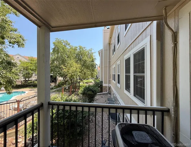 a view of a balcony with wooden floor and outdoor space