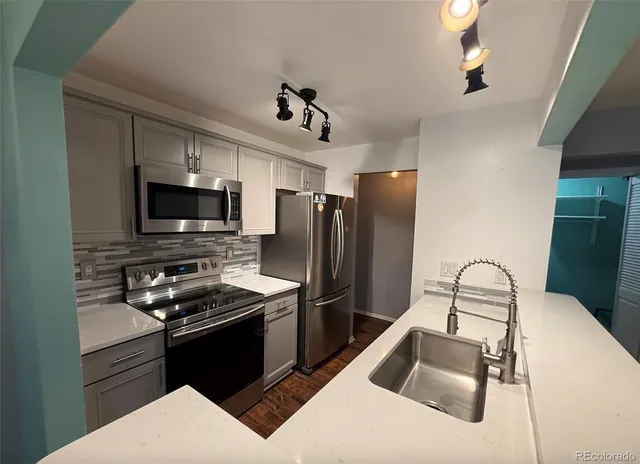 a kitchen with a refrigerator sink and microwave
