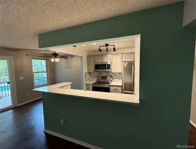 a kitchen with stainless steel appliances a refrigerator and a stove