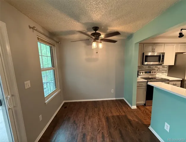 a kitchen with microwave a stove and a window