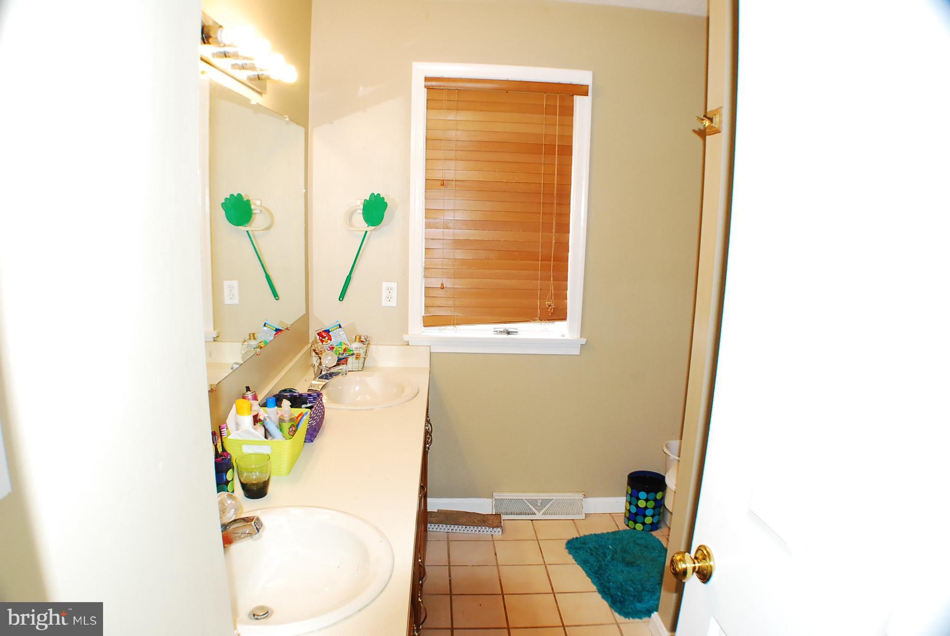 350 Redland Road Cross Junction, VA 22625 - Photo 17 of 30 a bathroom with a sink a toilet and a window