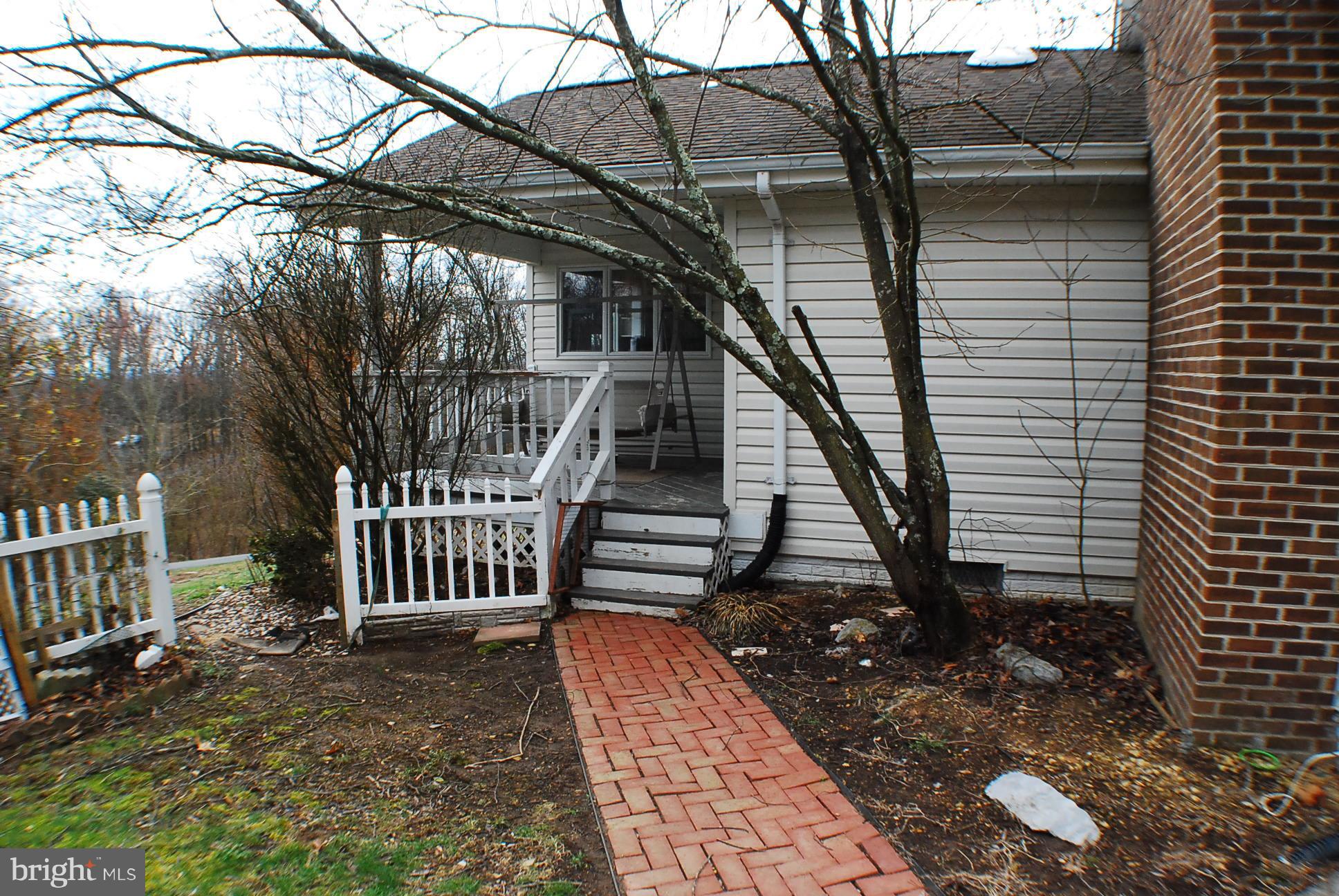 350 Redland Road Cross Junction, VA 22625 - Photo 22 of 30 a view of a house with backyard and wooden deck