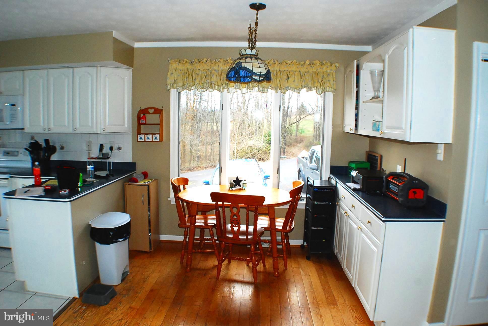 350 Redland Road Cross Junction, VA 22625 - Photo 7 of 30 a kitchen with a table chairs stove and cabinets