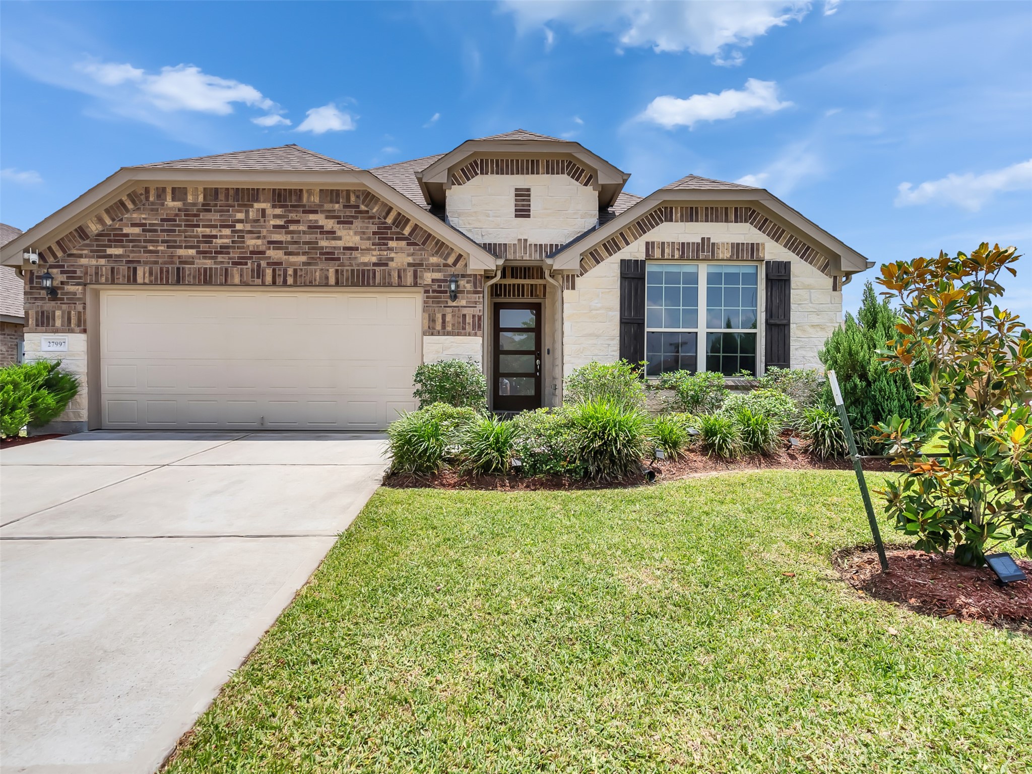 27997 Lone Hollow Lane Spring, TX 77386 - Photo 7 of 45 a front view of a building with a garden