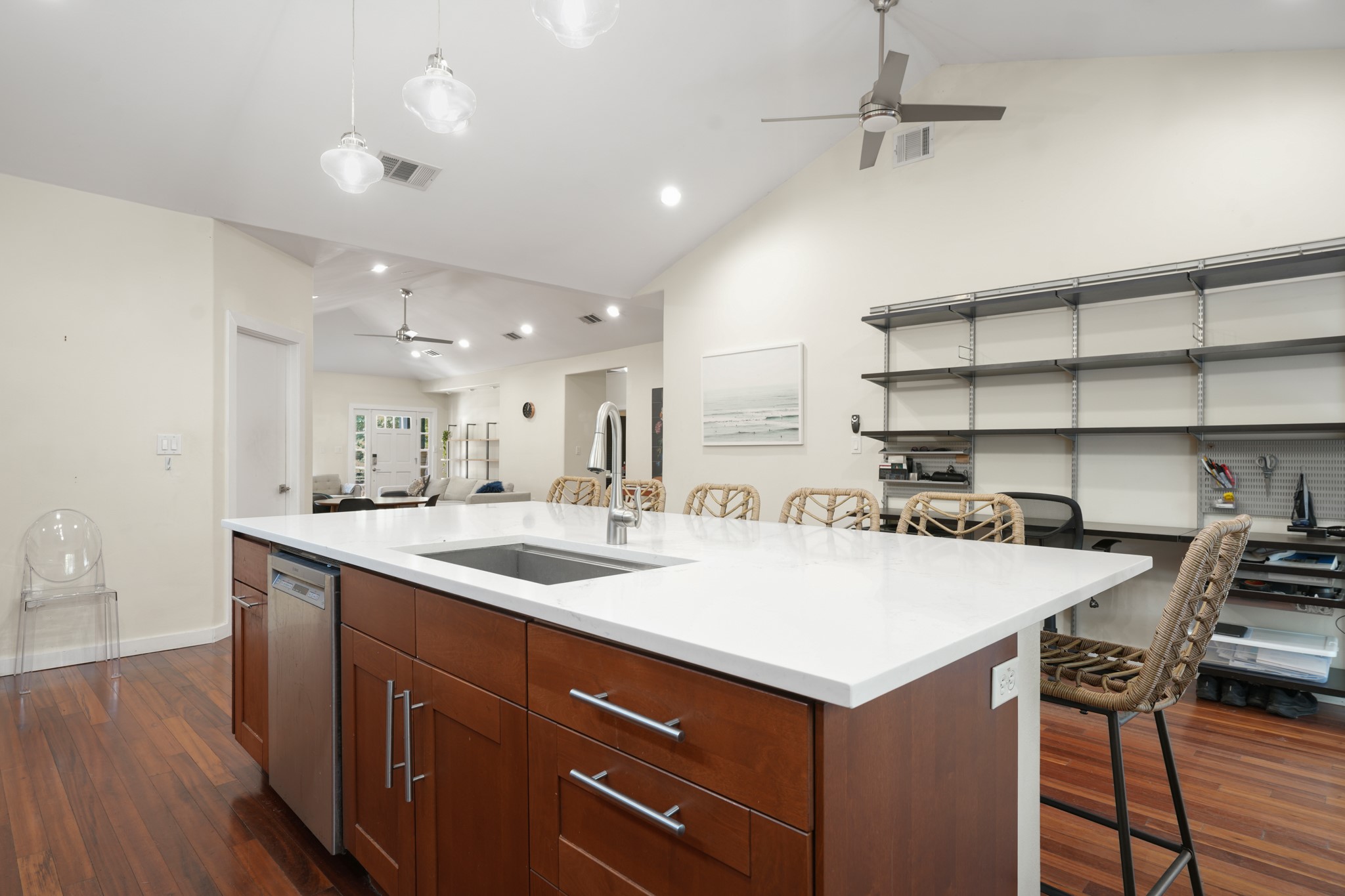 2501 Del Curto Road Austin, TX 78704 - Photo 10 of 26 Gleaming wood floors and vaulted ceilings frame a spacious center island with stone counters.