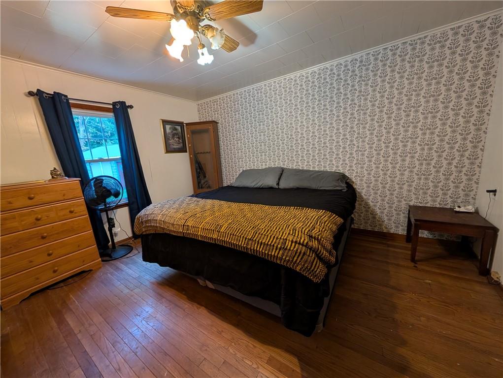 205 Woods Road Ligonier, PA 15658 - Photo 9 of 32 a bedroom with a bed and wooden floor