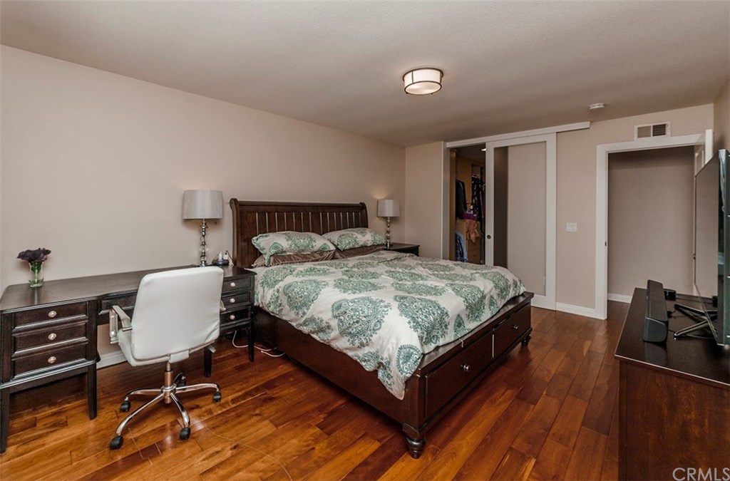 8 Hawthorn Irvine, CA 92612 - Photo 13 of 27 a bed sitting in a spacious bedroom next to a window and chair