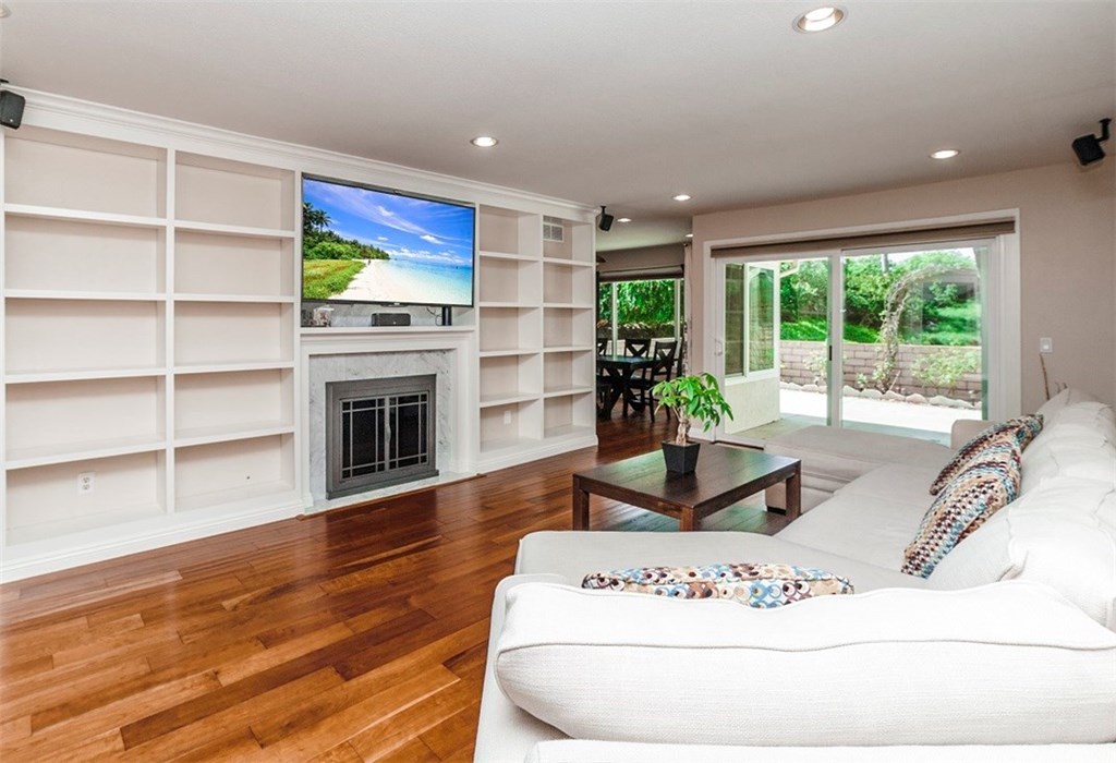 8 Hawthorn Irvine, CA 92612 - Photo 4 of 27 a living room with furniture hard wood floor and a fireplace