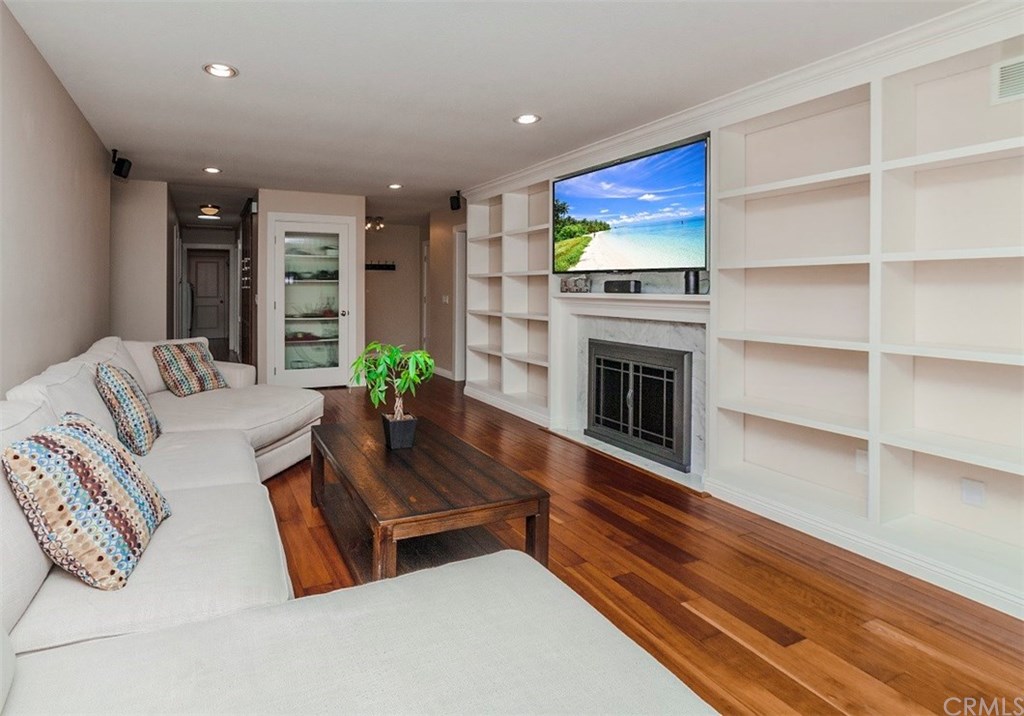 8 Hawthorn Irvine, CA 92612 - Photo 5 of 27 a living room with furniture flat screen tv and a fireplace