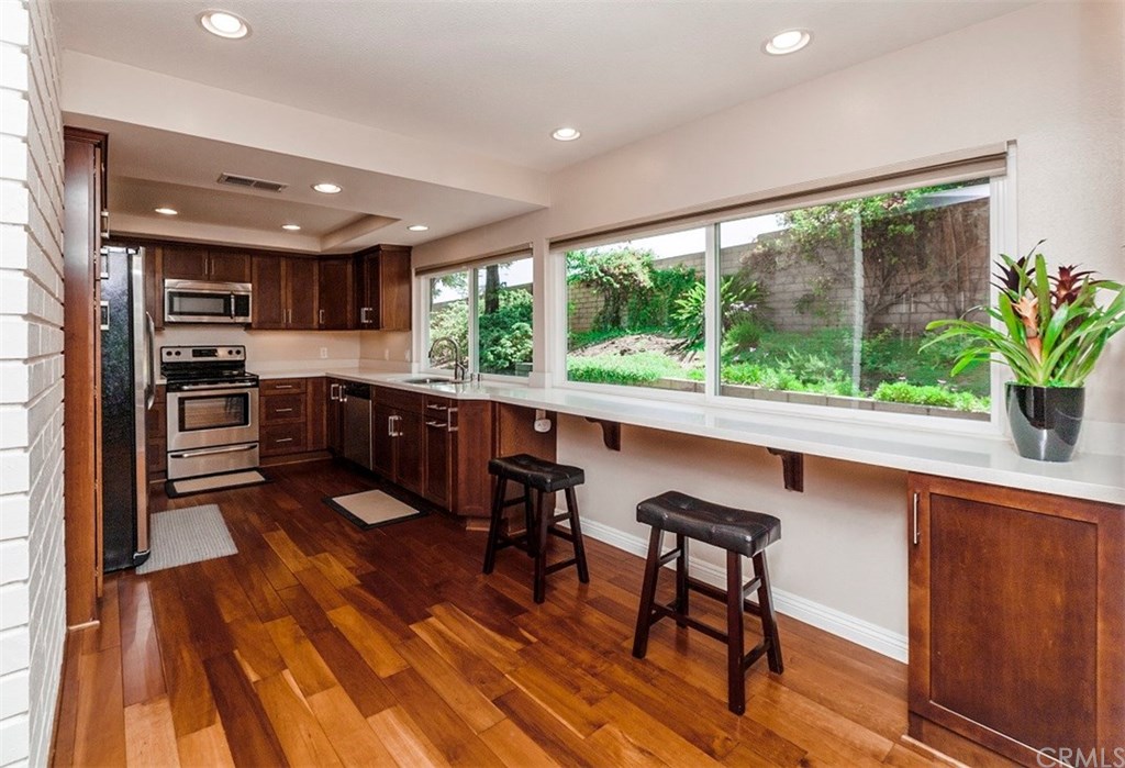 8 Hawthorn Irvine, CA 92612 - Photo 9 of 27 a kitchen with stainless steel appliances granite countertop sink stove top oven and cabinets