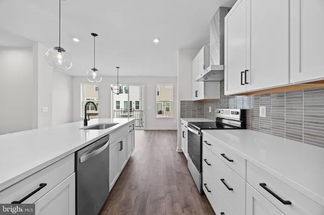 a view of a room with wooden floor and windows