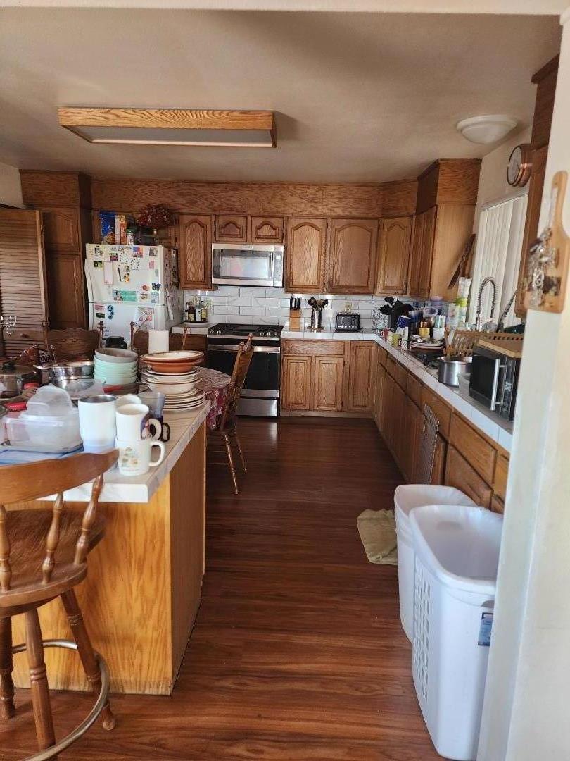 70 Overpass Road Watsonville, CA 95076 - Photo 14 of 29 a kitchen with stainless steel appliances a stove a sink dishwasher and a refrigerator