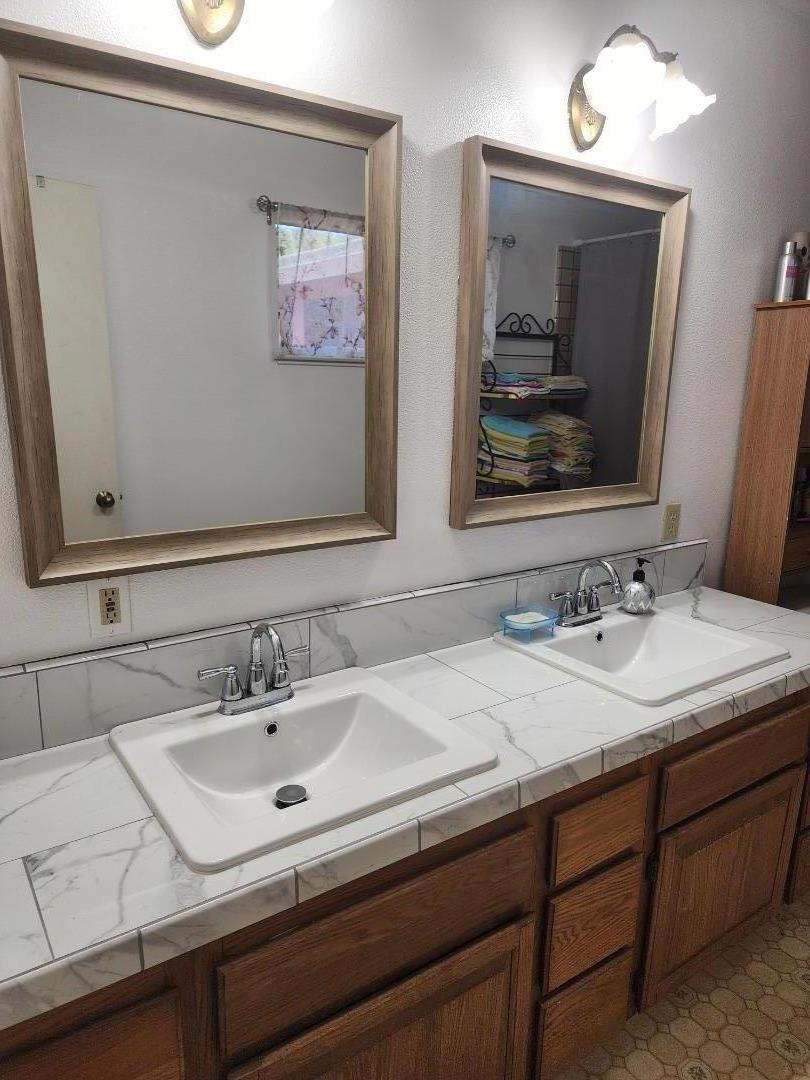 70 Overpass Road Watsonville, CA 95076 - Photo 23 of 29 a bathroom with a sink and a mirror
