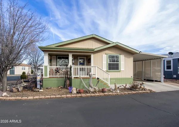 a front view of a house with a garden and porch