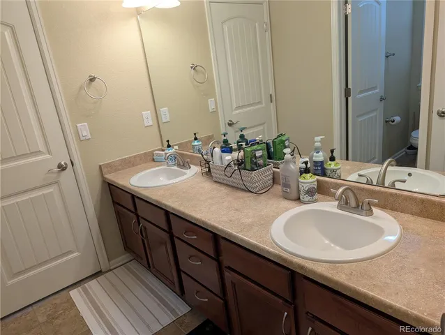 a bathroom with double sink and a mirror