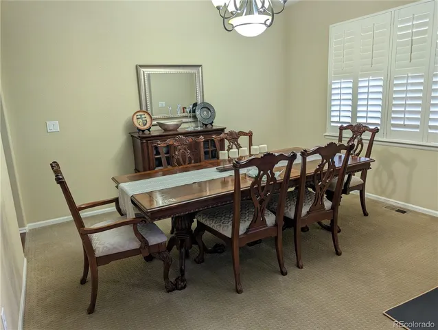 a view of a dining room with furniture and window