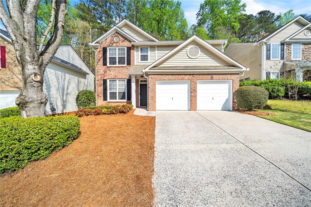 1981 Ridgestone Run Southwest Marietta, GA 30008 - Photo 1 of 1 a front view of a house with a yard and garage