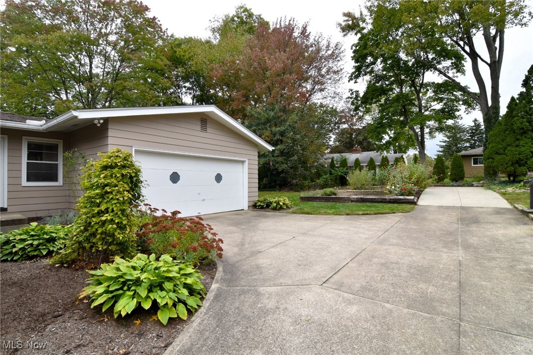2071 Wyndham Road Akron, OH 44313 - Photo 35 of 42 View of side facing 2 car garage and parking pad with garden. Beautiful landscaping!