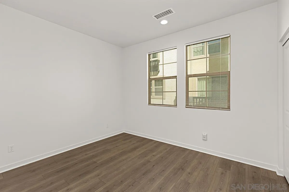 340 Millstream Court Santee, CA 92071 - Photo 11 of 19 an empty room with wooden floor and windows