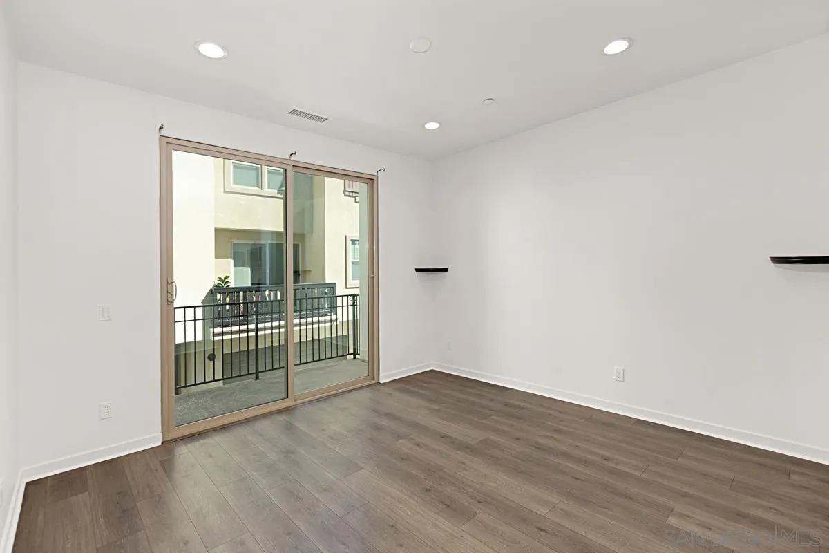 340 Millstream Court Santee, CA 92071 - Photo 2 of 19 an empty room with wooden floor and windows