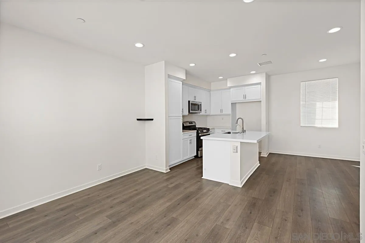 340 Millstream Court Santee, CA 92071 - Photo 3 of 19 a view of a kitchen with wooden floor and white cabinets