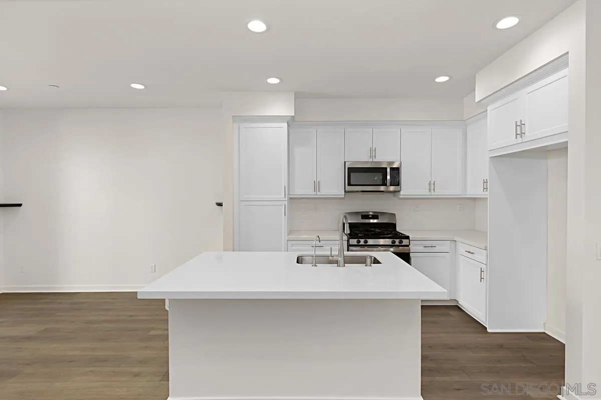 340 Millstream Court Santee, CA 92071 - Photo 6 of 19 a kitchen with a sink stainless steel appliances and white cabinets