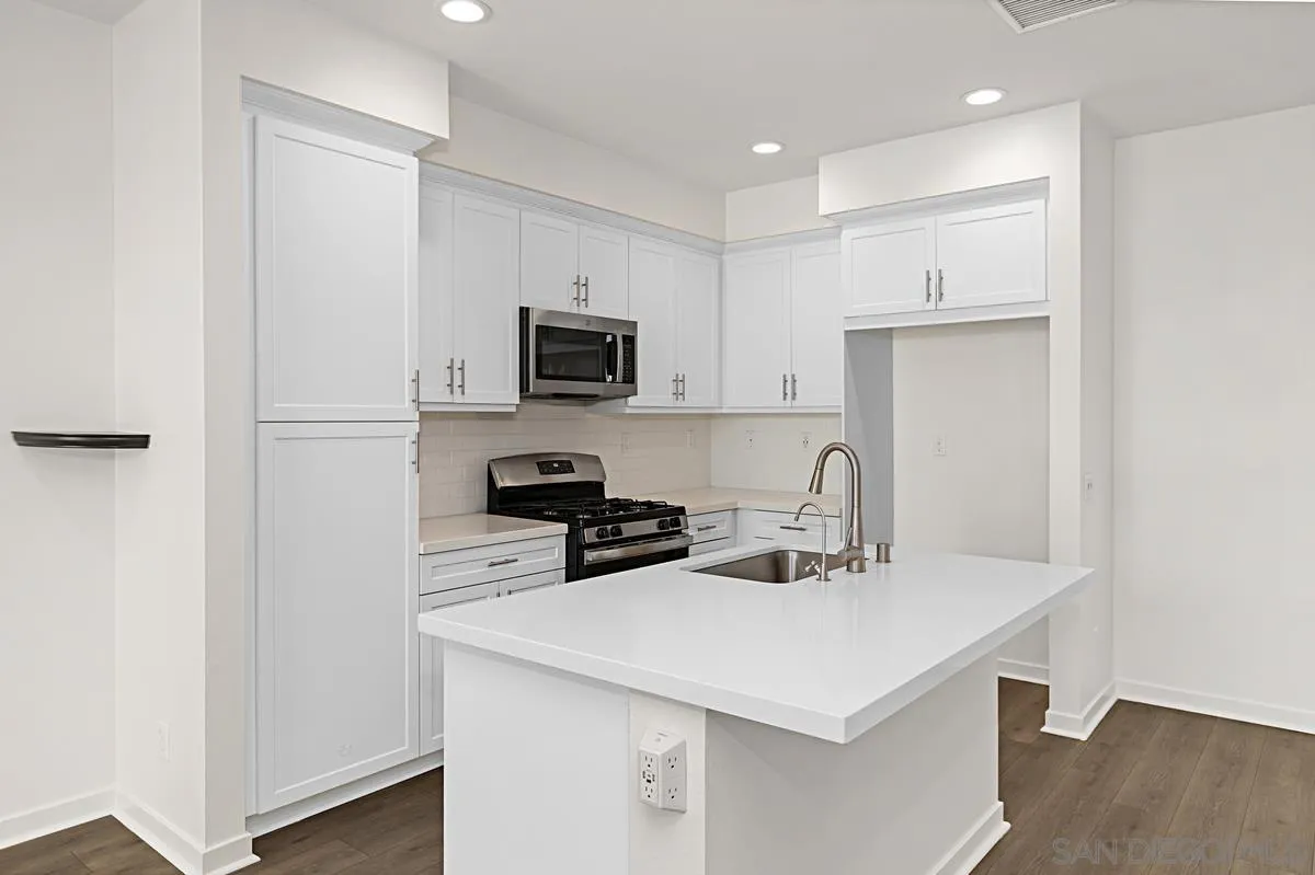 340 Millstream Court Santee, CA 92071 - Photo 7 of 19 a kitchen with a refrigerator a sink a stove a microwave and wooden floor