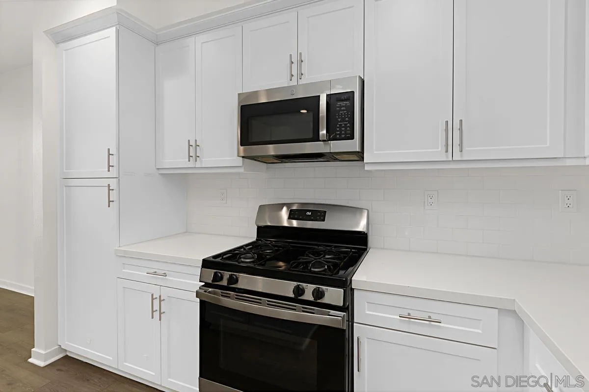 340 Millstream Court Santee, CA 92071 - Photo 8 of 19 a kitchen with stainless steel appliances granite countertop white cabinets and a stove a oven with white countertops
